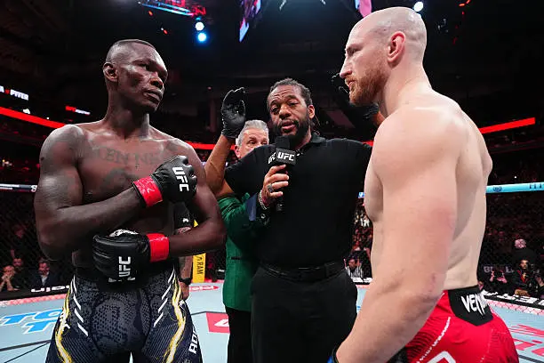 Cover Image for “HE CHEATED!” Just minutes after his crushing defeat at UFC Fight Night, Israel Adesanya stunned everyone by claiming he had evidence suggesting that large sums of money were allegedly transferred to referee Herb Dean,
